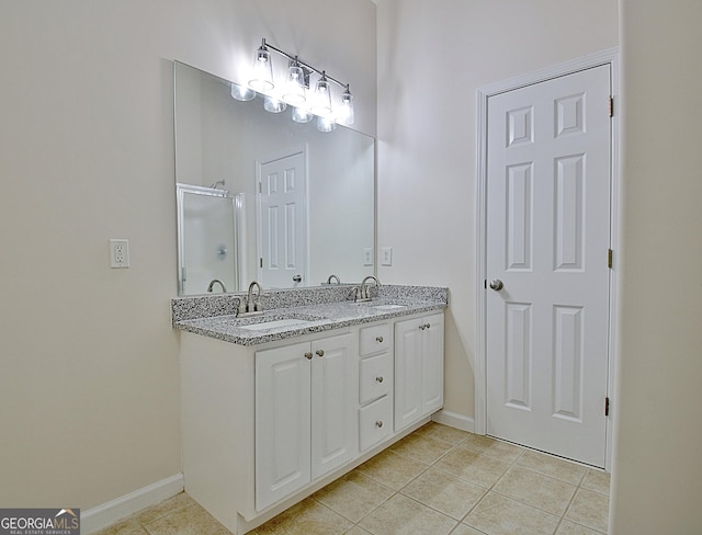 bathroom with tile patterned flooring, vanity, and a shower with door