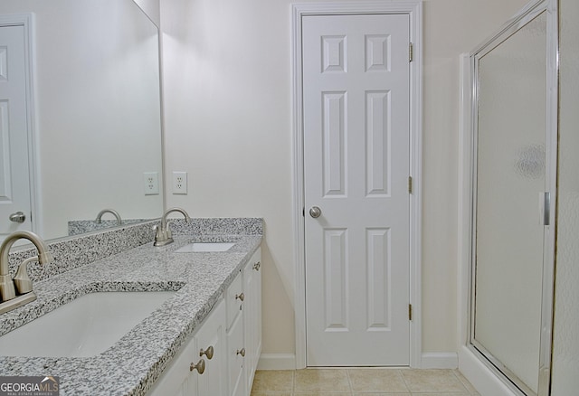 bathroom with tile patterned floors, vanity, and a shower with shower door