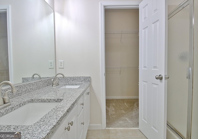 bathroom featuring tile patterned floors, vanity, and walk in shower