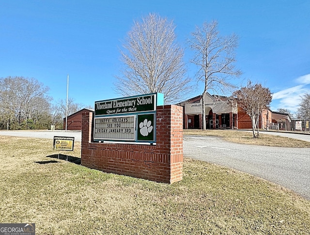 community sign featuring a lawn