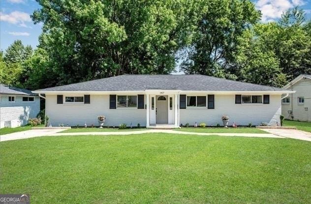 ranch-style house with a front lawn