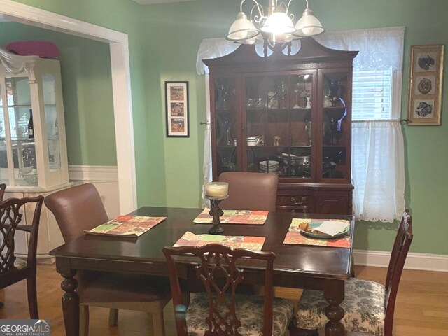 dining space featuring a chandelier and wood-type flooring