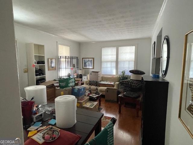 interior space with crown molding and hardwood / wood-style flooring