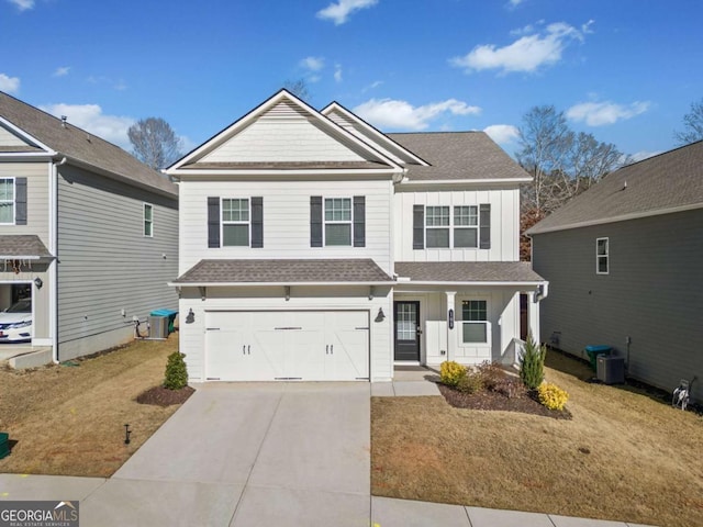 view of front of home featuring central air condition unit, a front lawn, a porch, and a garage