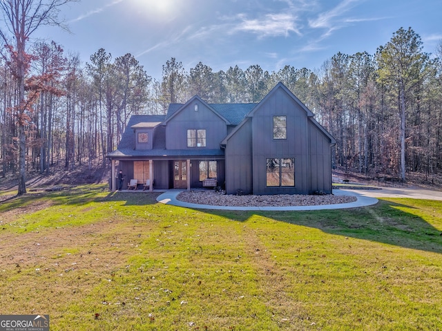 rear view of property featuring a yard