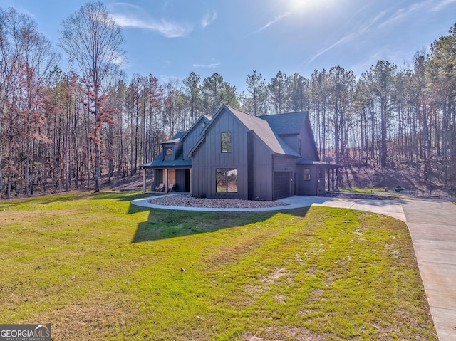 view of property exterior featuring a yard and a garage