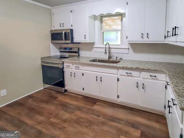 kitchen with sink, appliances with stainless steel finishes, backsplash, dark hardwood / wood-style floors, and white cabinets