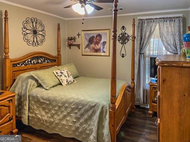 bedroom featuring crown molding, dark wood-type flooring, and ceiling fan