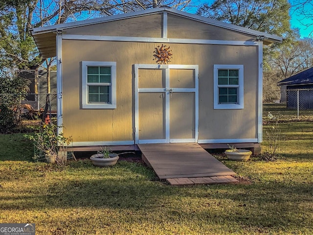 view of outbuilding featuring a lawn