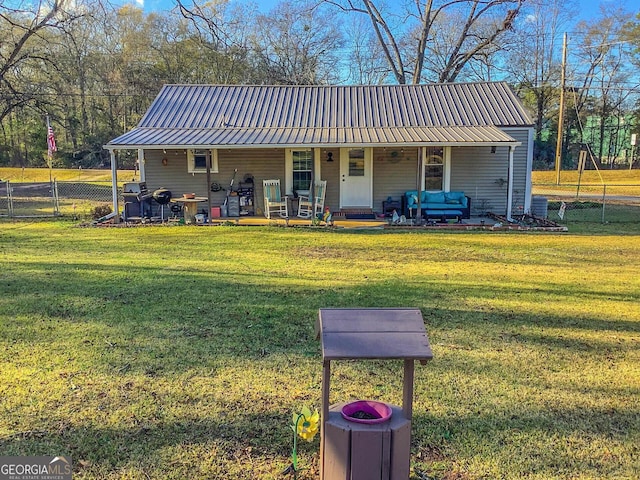 view of front of home with an outdoor hangout area and a front lawn