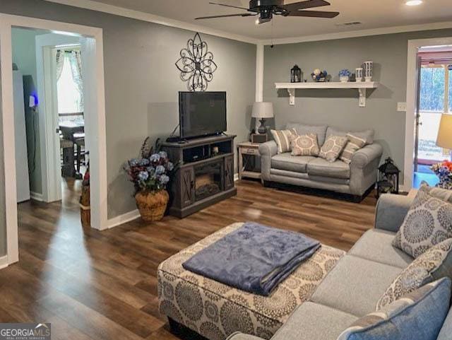 living room with crown molding, ceiling fan, and dark hardwood / wood-style flooring