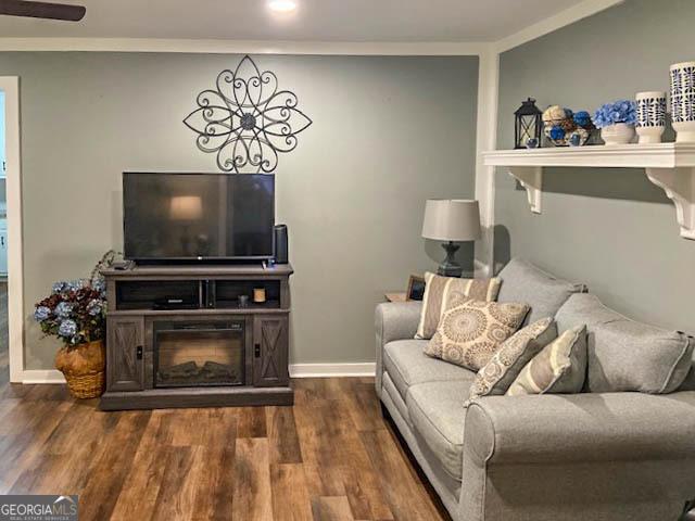 living room with ornamental molding and dark hardwood / wood-style floors