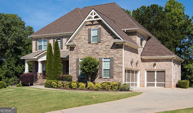 view of front of property featuring a garage and a front yard