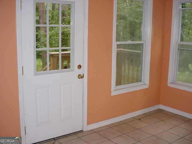 doorway with light tile patterned flooring