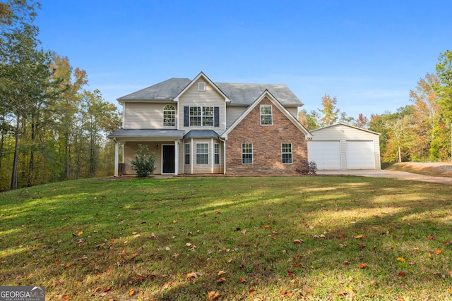 view of front of house with a garage, an outdoor structure, and a front yard