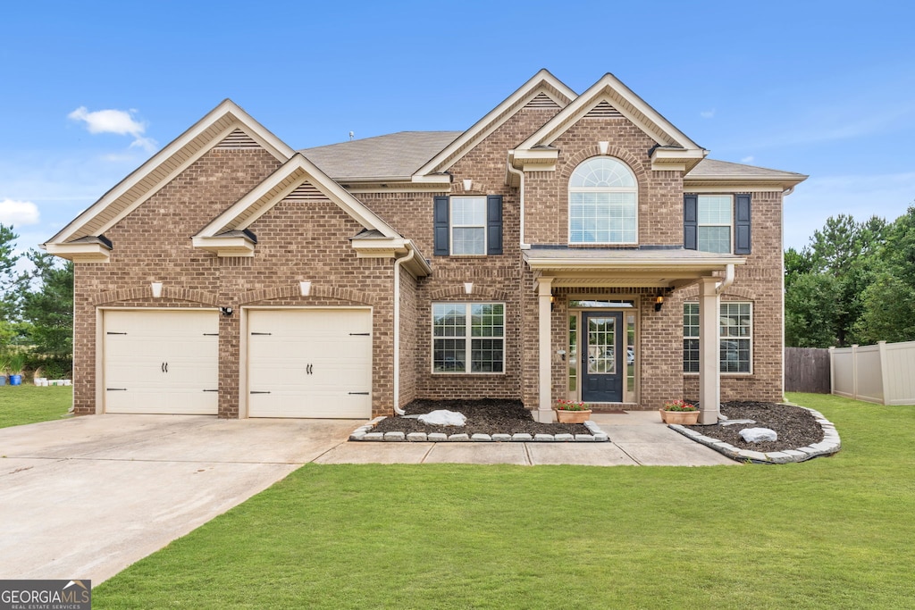 view of front facade with a garage and a front lawn