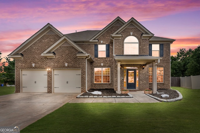 view of front of house featuring a yard and a garage