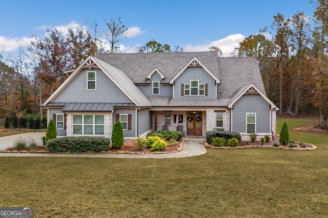 craftsman house featuring covered porch and a front lawn