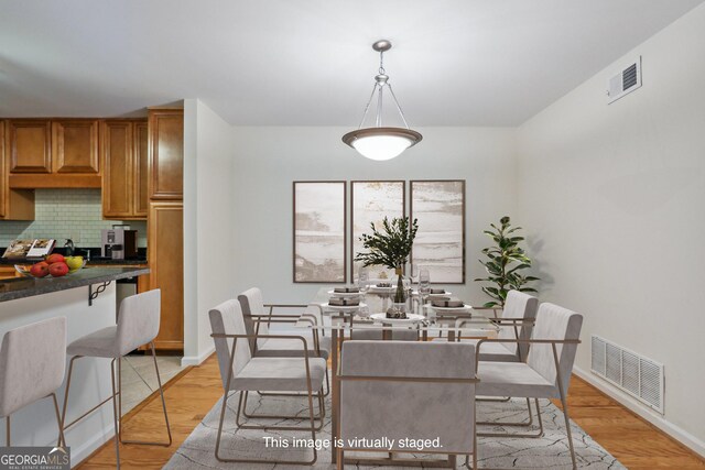 dining room with light wood-type flooring