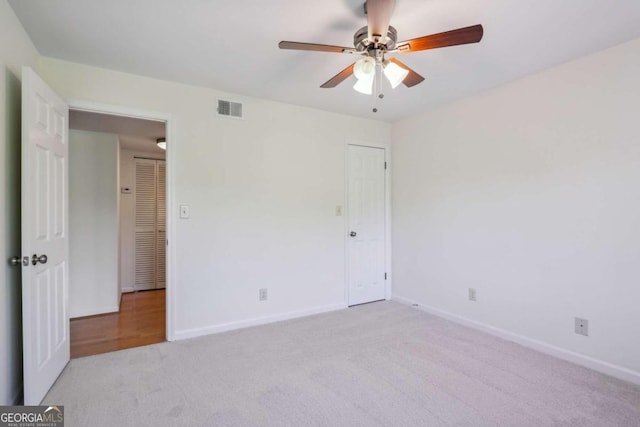 unfurnished bedroom featuring ceiling fan and light carpet