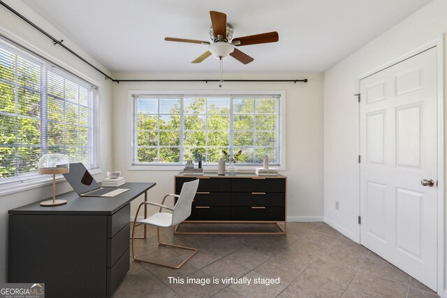 office featuring light tile patterned floors and ceiling fan