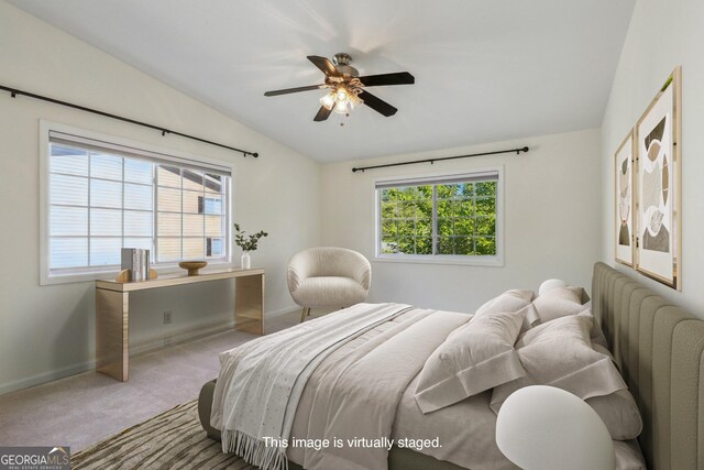 bedroom with multiple windows, carpet, ceiling fan, and lofted ceiling