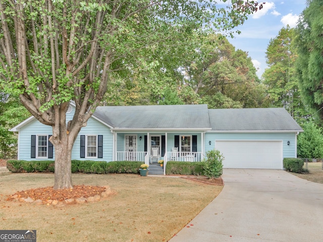 single story home featuring covered porch, a front yard, and a garage