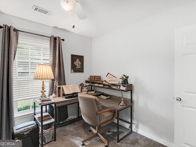 carpeted office with a wealth of natural light and ceiling fan