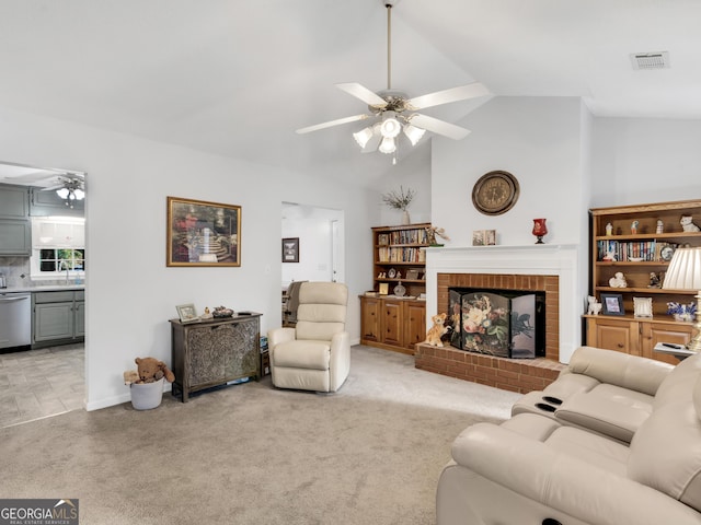 carpeted living room featuring ceiling fan, vaulted ceiling, and a brick fireplace