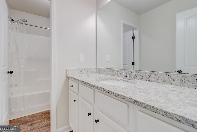 full bath featuring shower / washtub combination, wood finished floors, and vanity