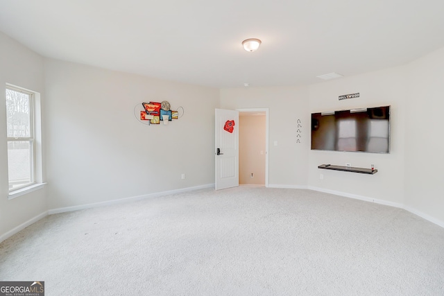 empty room featuring carpet floors and baseboards