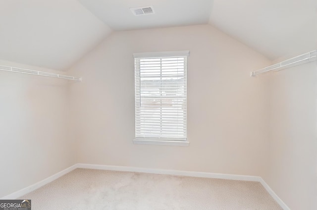 spacious closet featuring lofted ceiling, carpet, and visible vents