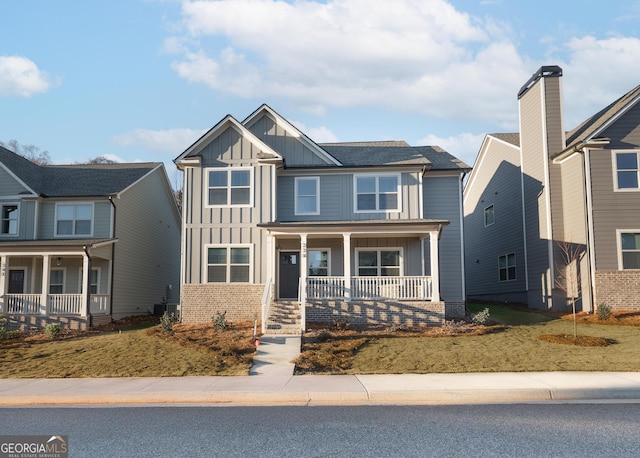 view of front of house featuring a porch and central AC