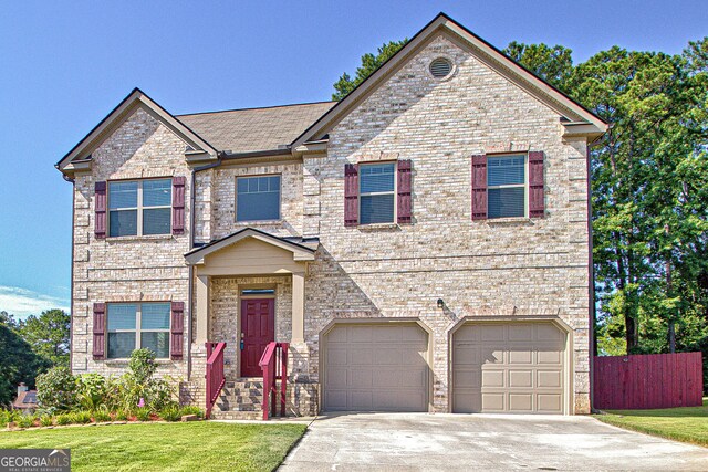 view of front of home with a front lawn and a garage