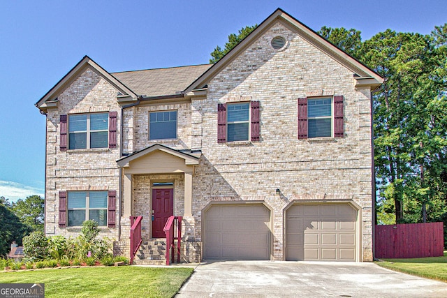 view of front of house featuring a garage and a front lawn