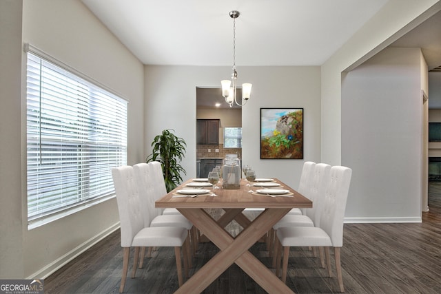 dining room featuring dark hardwood / wood-style flooring and a notable chandelier