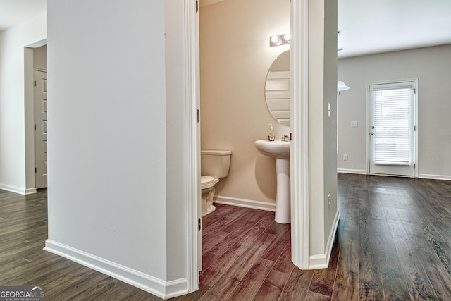 bathroom with hardwood / wood-style floors and toilet