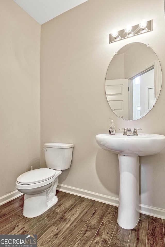 bathroom featuring sink, hardwood / wood-style flooring, and toilet