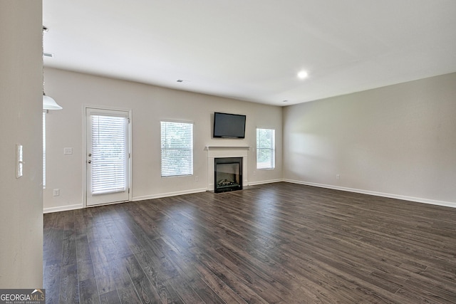 unfurnished living room featuring dark hardwood / wood-style floors