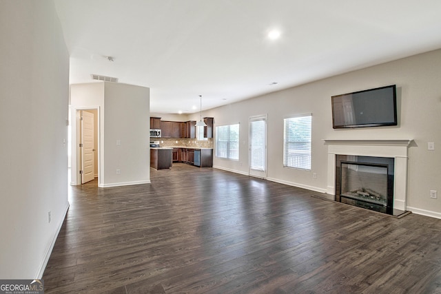 unfurnished living room with dark hardwood / wood-style floors