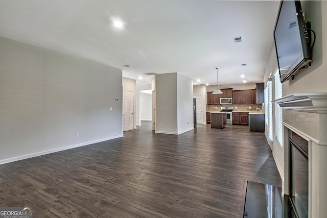 unfurnished living room featuring dark hardwood / wood-style flooring