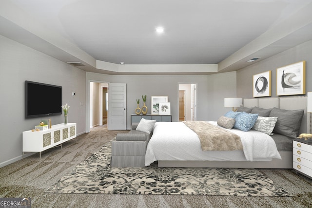 bedroom featuring a tray ceiling and carpet