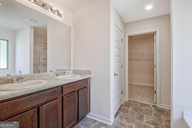 bathroom with vanity and an enclosed shower