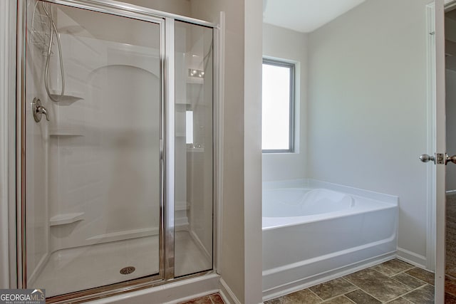 bathroom featuring separate shower and tub