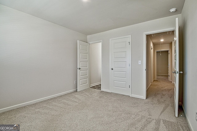 unfurnished bedroom featuring light colored carpet