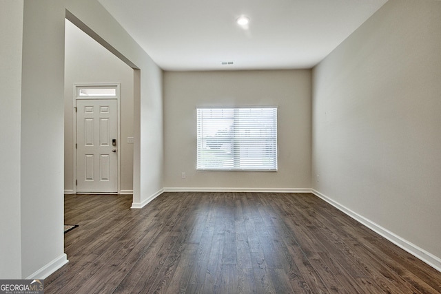 spare room featuring dark hardwood / wood-style flooring