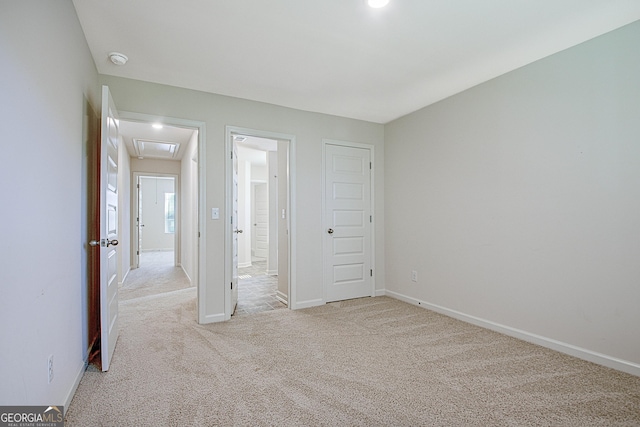 unfurnished bedroom featuring light colored carpet