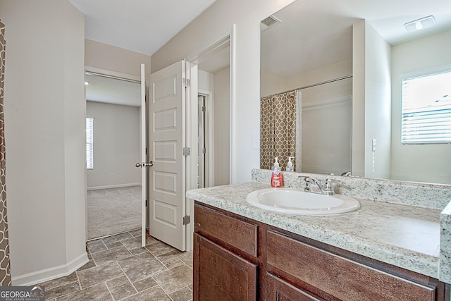 bathroom featuring vanity and a wealth of natural light