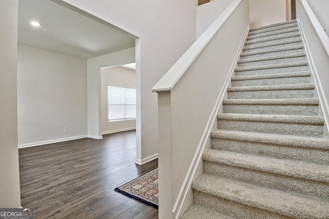 staircase with wood-type flooring