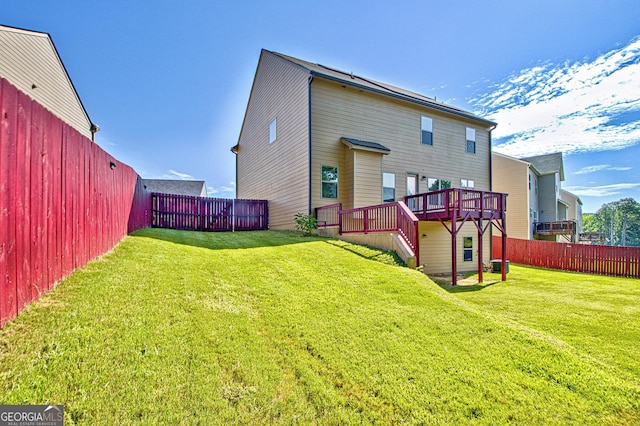 back of property with a yard and a deck